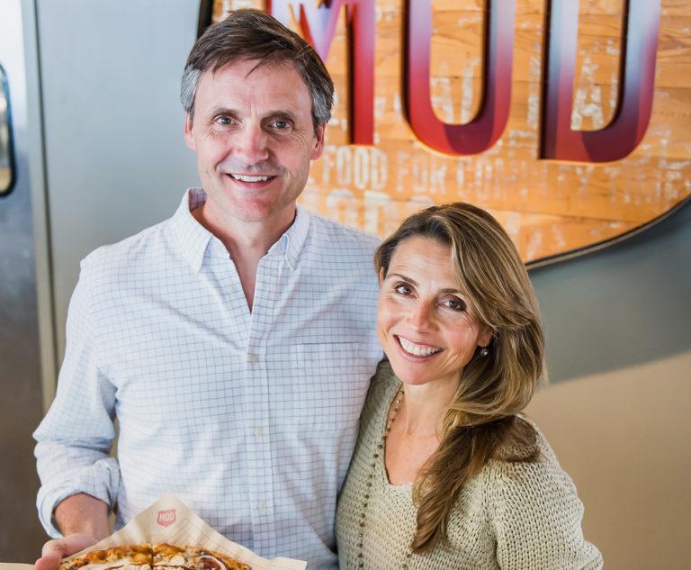 MODs founders Scott and Ally Svenson holding a pizza.